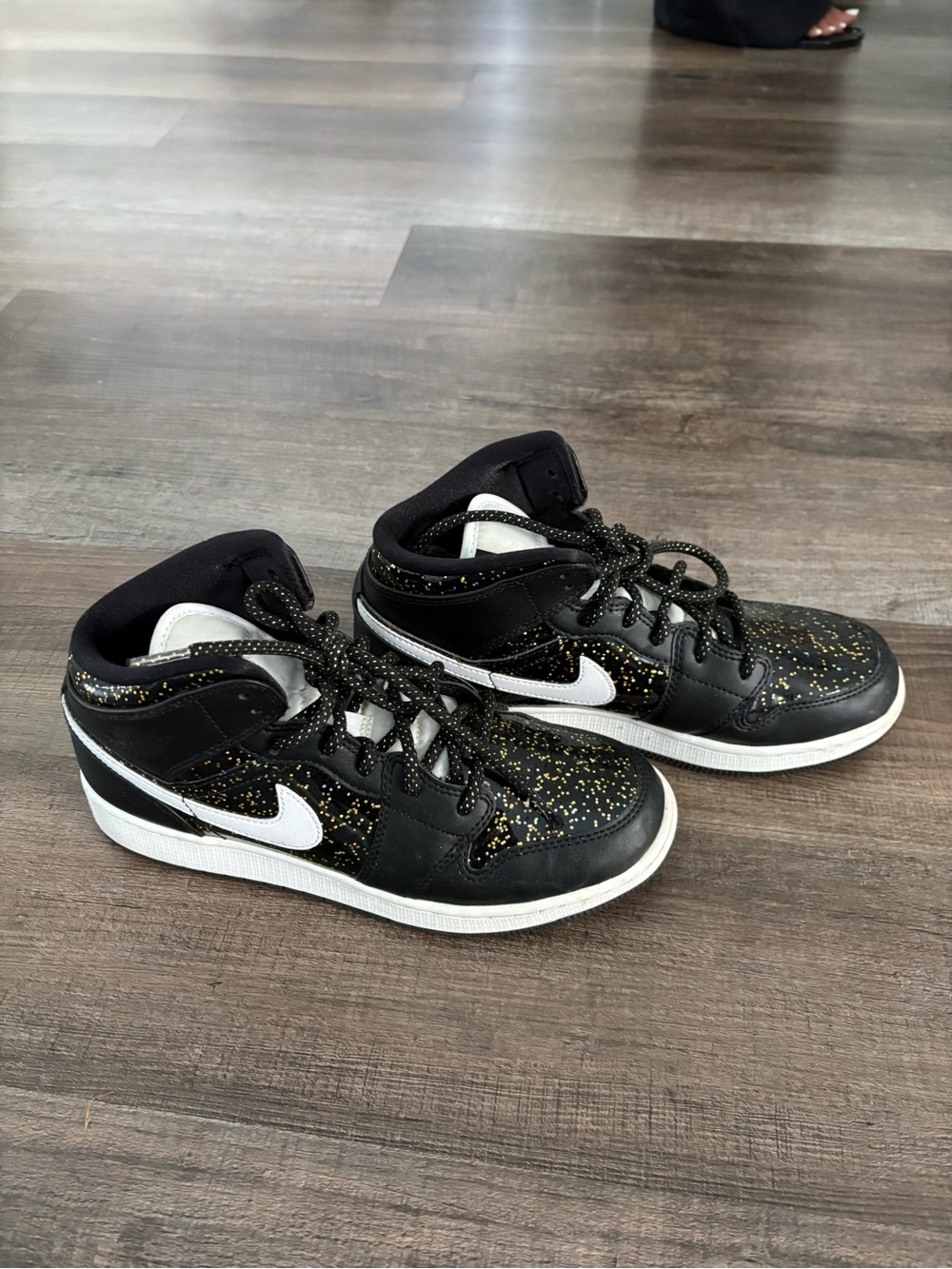Jordan women’s Black High-Top Sneakers with White Swoosh and Gold Fleck
